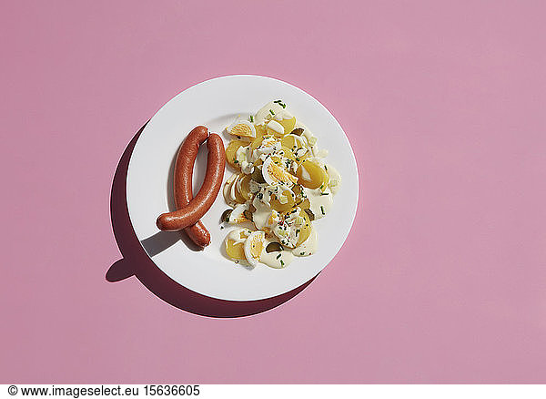 Directly above shot of healthy egg meal by ingredient in plate on pink background