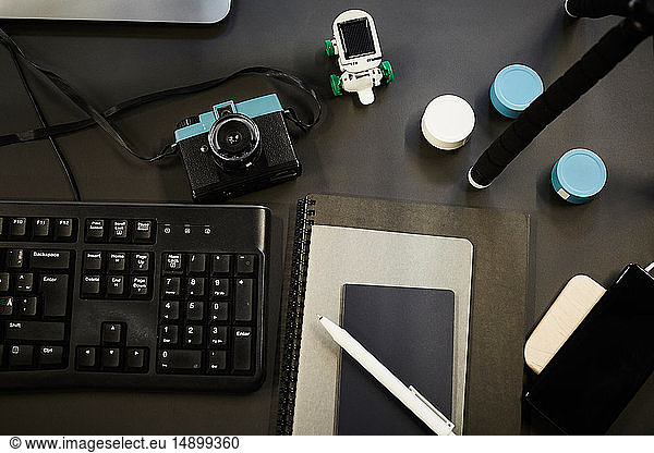 Directly above shot of various technologies and diaries on desk in office