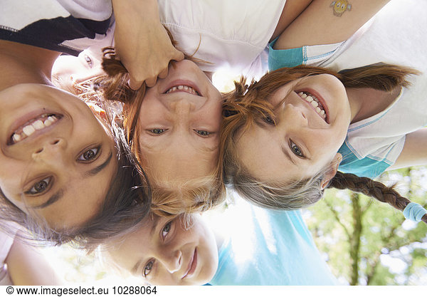 Directly below shot of five girls playing in huddle  Bavaria  Germany