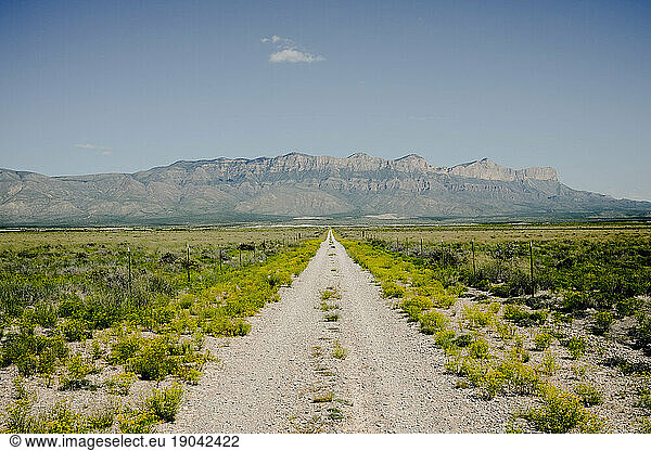 Dirt Road Leading To Mountains In West Texas