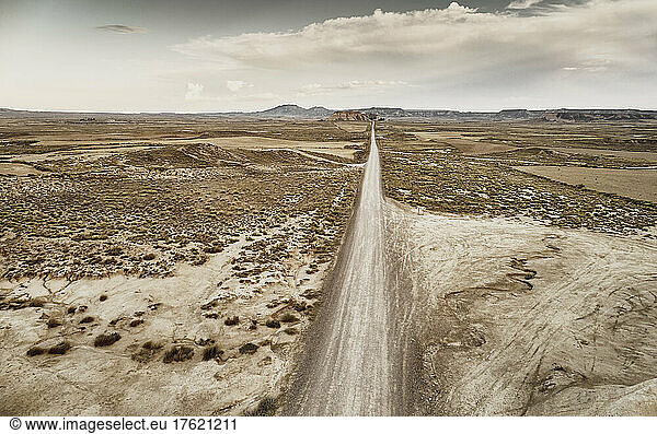 Dirt road passing through desert landscape at Bardenas Reales  Spain
