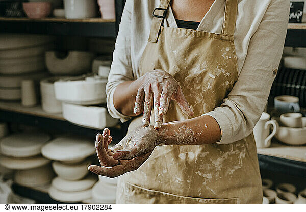Dirty hands of craftswoman at workshop
