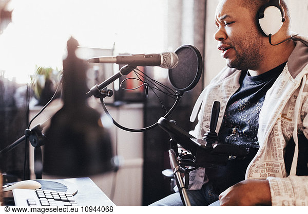 Disabled male singer recording music in studio