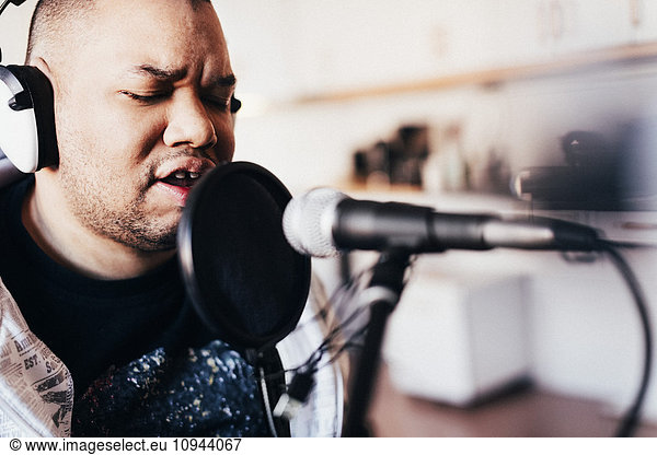 Disabled male singer singing in recording studio