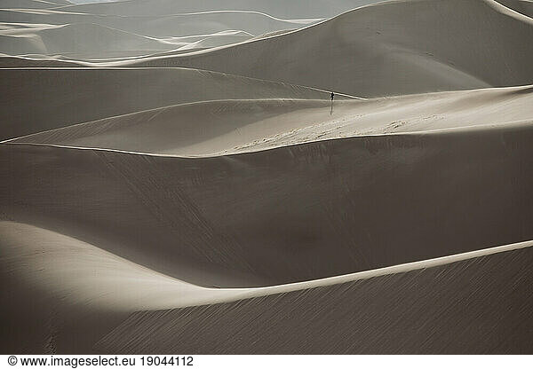 distant hiker explores the ridges of great sand dunes national park