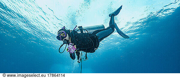 Diver emerging into the tropical waters of the Andaman Sea