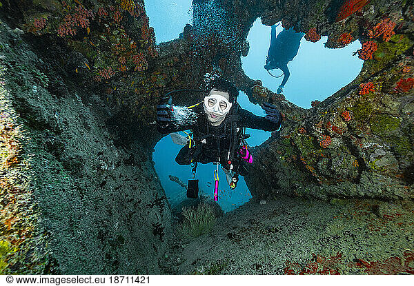 diver exploring shipwreck in the Maldives