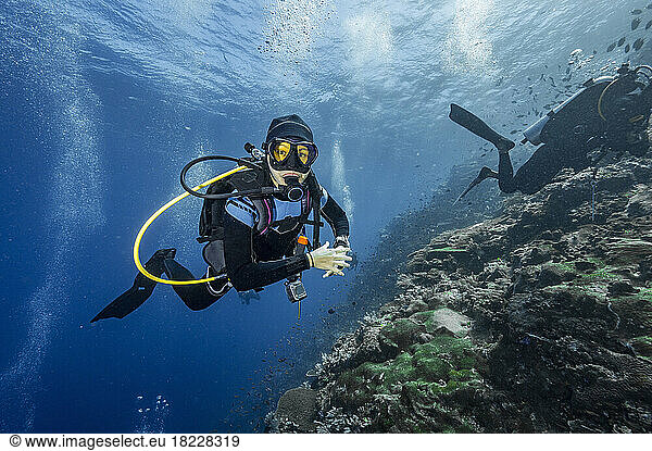Diver exploring the coral reefs at Komodo / Indonesia