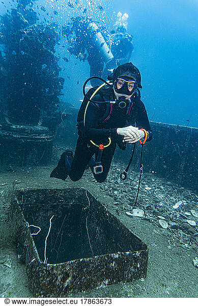 diver exploring the wreck of the HTMS Sattakut in Thailand