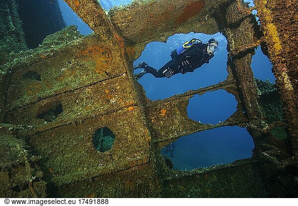 Diver looking into interior of sunken ship decaying rusting shipwreck Elviscot  Scoglio dell' Ogliera  Pomonte  Elba  Tuscany  Italy  Europe