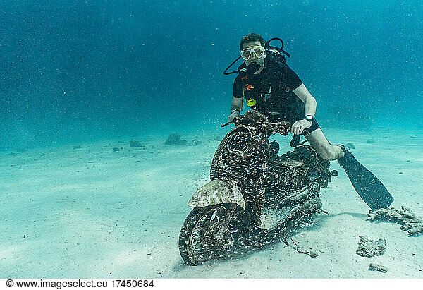 diver posing on motorbike on the ocean floor at Phuket