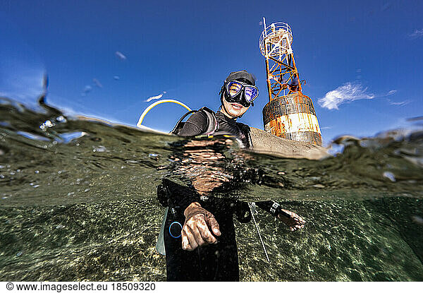 Diver surfacing at the rocky island of Losin in the Gulf of Thailand