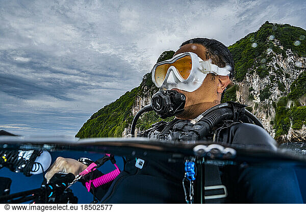 diver surfacing in the tropical waters of the Banda Sea