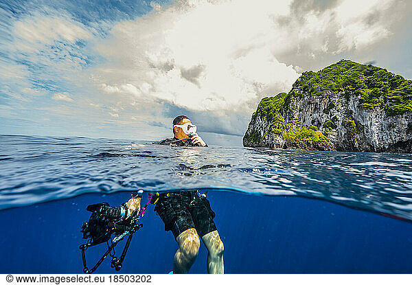 diver surfacing in the tropical waters of the Banda Sea