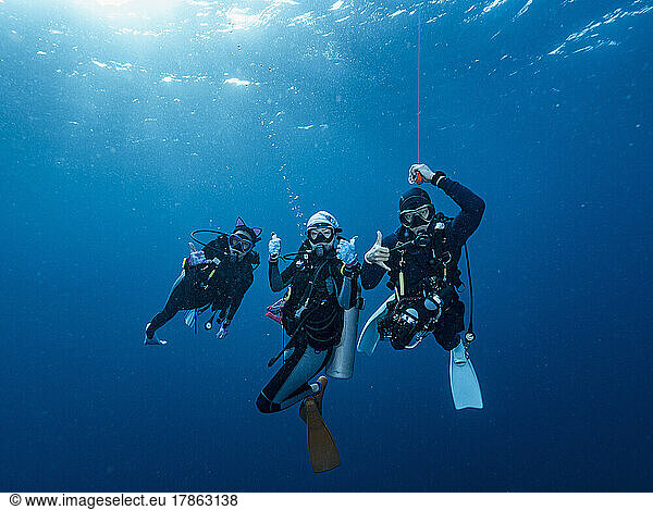 divers at safety stop in the tropical waters of the Andaman Sea