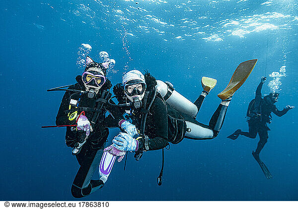 divers at safety stop in the tropical waters of the Andaman Sea