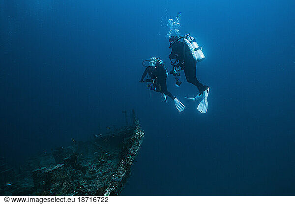 divers exploring shipwreck in the Maldives