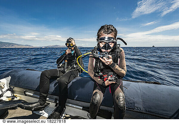 divers performing a backroll close to Flores Island in Komodo