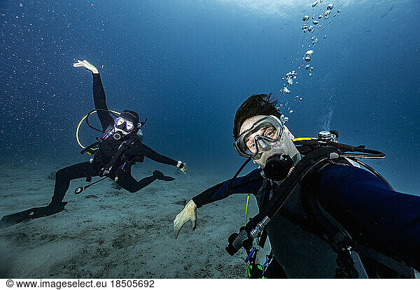 divers posing in the clear water of the Andaman Sea / Thailand