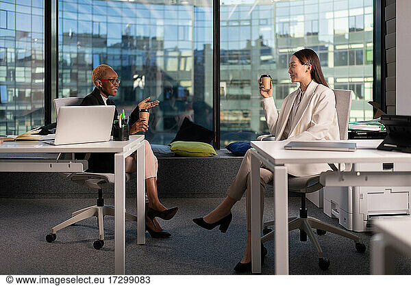 Diverse businesswomen talking during break