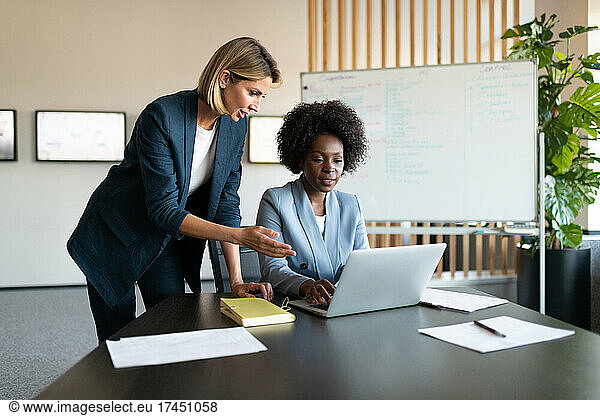 Diverse businesswomen using netbook together