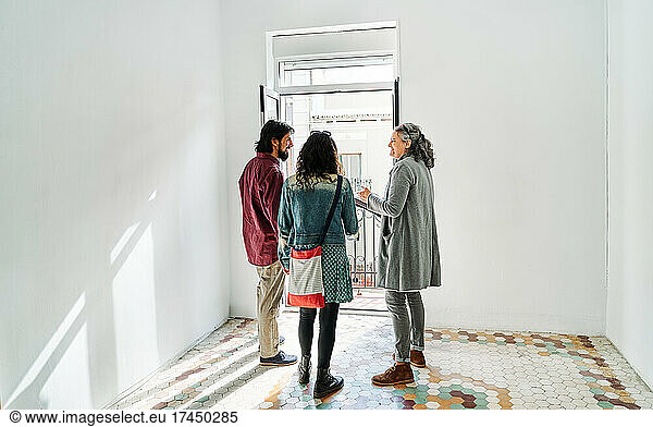 Diverse couple and real estate agent examining rental options