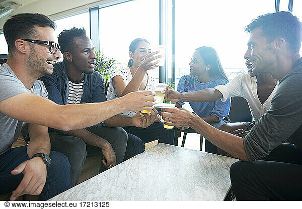 Diverse group of business people enjoying beers in office