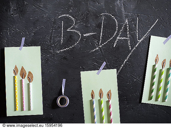 DIY birthday cards hanging on blackboard