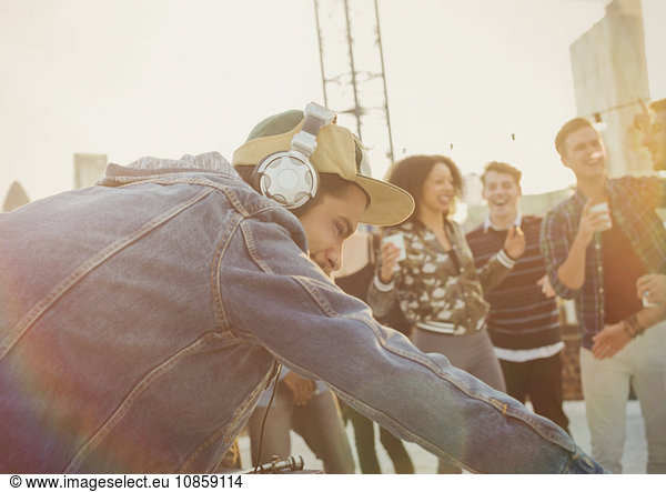 DJ with headphones at rooftop party