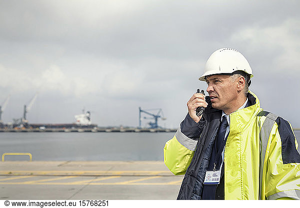 Dock manager with walkie-talkie at shipyard