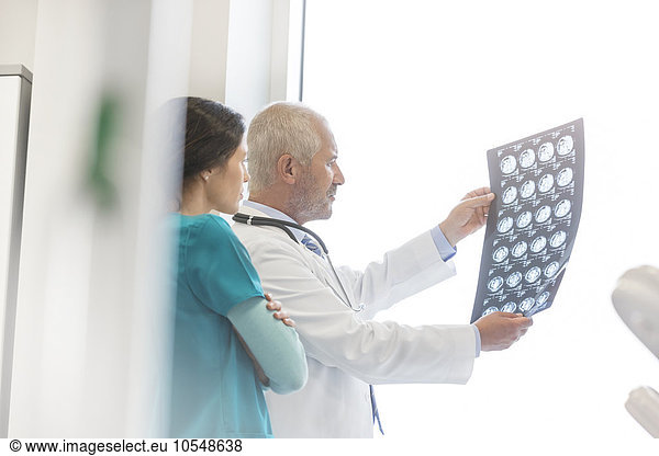 Doctor and nurse reviewing x-rays in doctor’s office