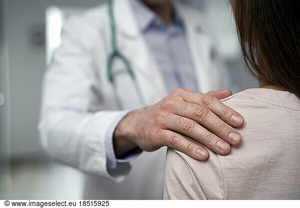 Doctor consoling patient at clinic
