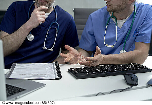 Doctor discussing with colleague at clinic