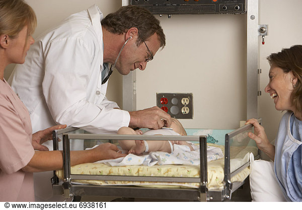 Doctor Examining Newborn