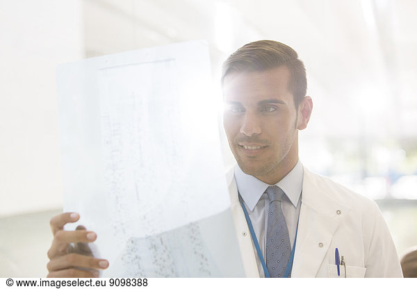 Doctor examining paperwork in hospital