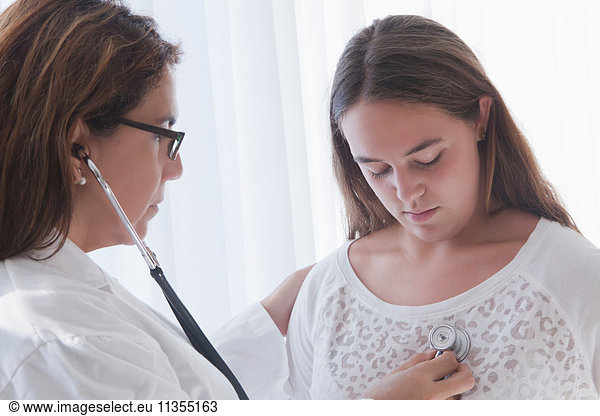 Doctor examining teenage girl