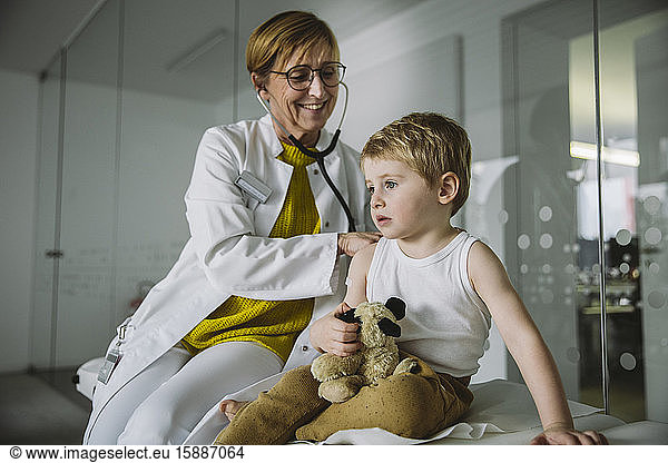 Doctor examining toddler boy with a stethoscope