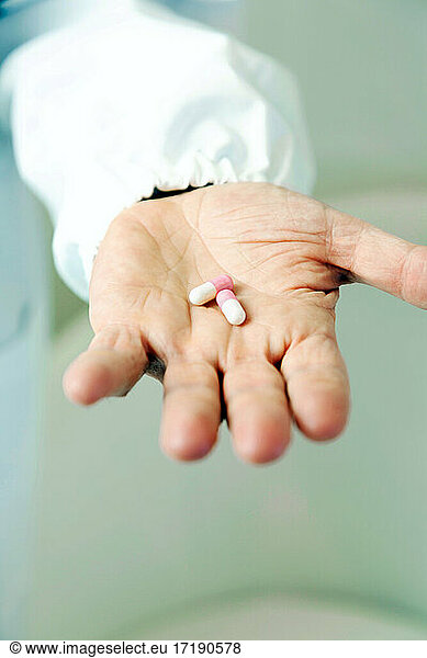 Doctor holding pills in hand