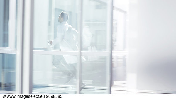 Doctor running in hospital corridor