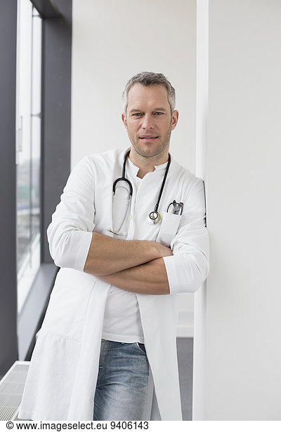 Doctor standing with arms crossed  portrait