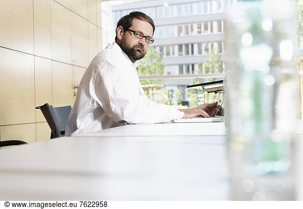 Doctor using laptop at desk