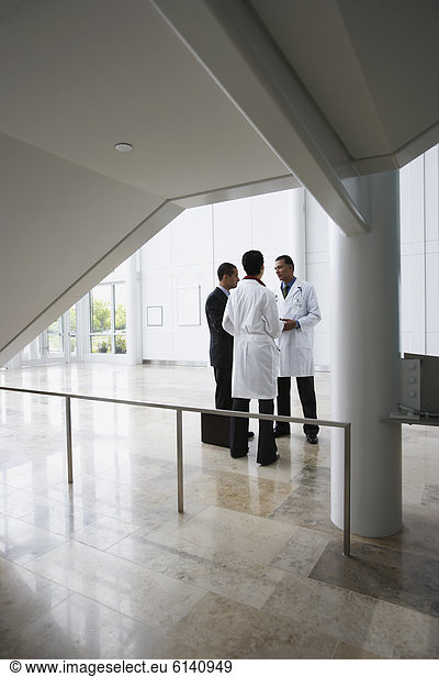 Doctors conferring with businessman