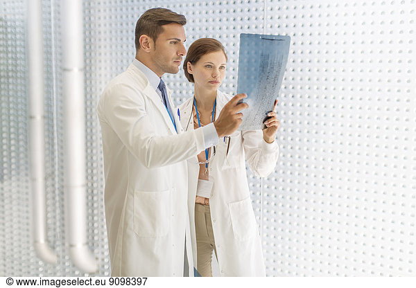 Doctors examining paperwork in hospital