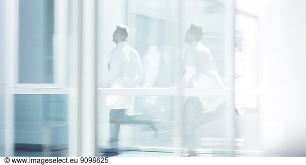 Doctors running in hospital corridor