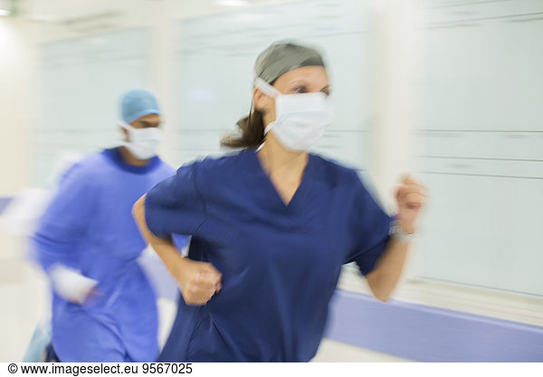 Doctors rushing through hospital corridor