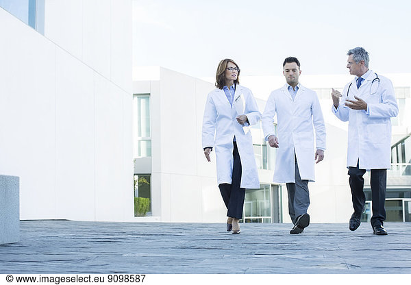 Doctors walking and talking on roof