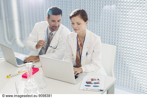 Doctors working at laptop