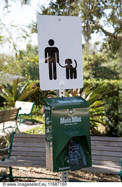Dog poo bag dispenser on an American sidewalk  Mount Dora Florida USA.