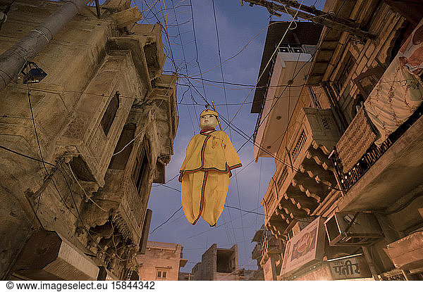 Doll hanged between typical houses of central streets of Jaisalmer