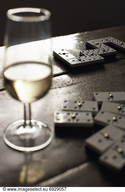Dominoes and White Wine on Table